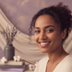 Portrait of a smiling woman with diverse features, exuding happiness and trust.